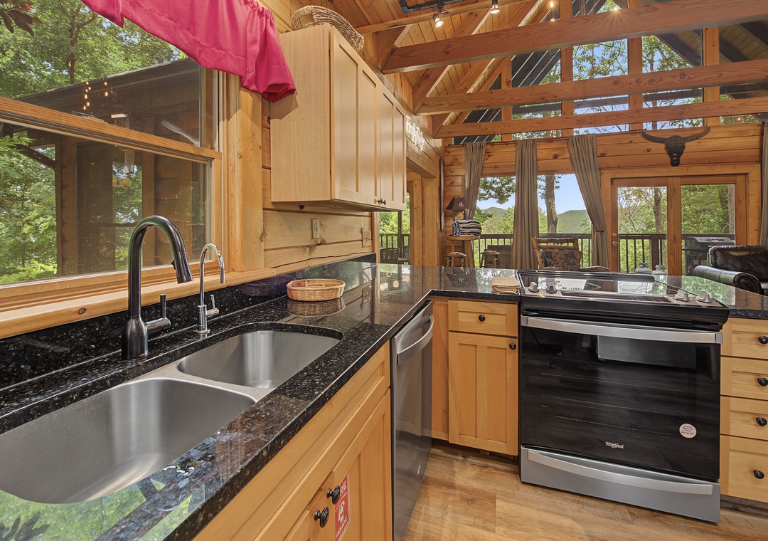 Prepare meals in your fully equipped kitchen with gleaming granite counters, stainless steel appliances, and sweeping forest views through floor-to-ceiling windows that bring the outdoors in.