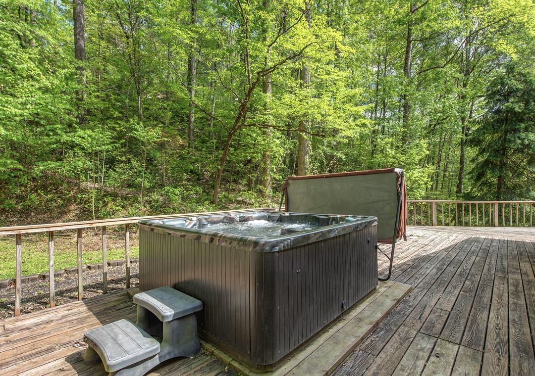 Soak in your private hot tub surrounded by towering trees, where forest whispers and bubbling water create the perfect woodland retreat.