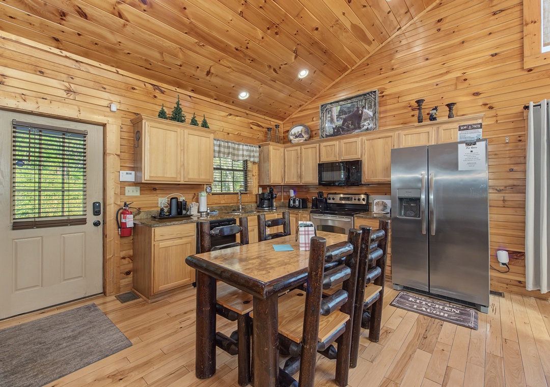 Your fully equipped kitchen awaits with rustic wood charm and modern appliances, perfect for preparing meals in cozy cabin comfort.