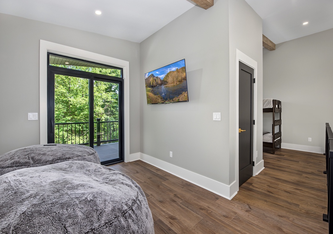 Wake up to peaceful forest views through your balcony doors and enjoy vaulted ceilings with rustic beams that add natural warmth to your restful retreat.