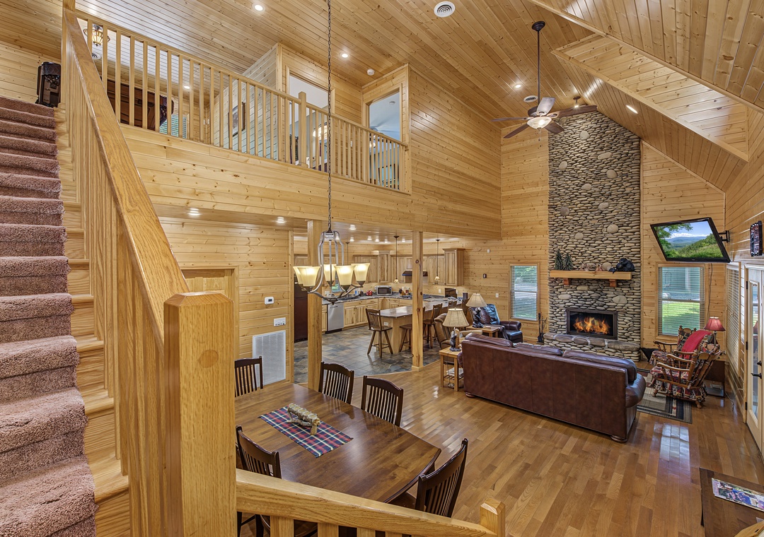 Soaring ceilings and warm wood surround you in this open-concept space, where your dining table, cozy fireplace, full kitchen, and lofted relaxation nook come together for memorable moments.