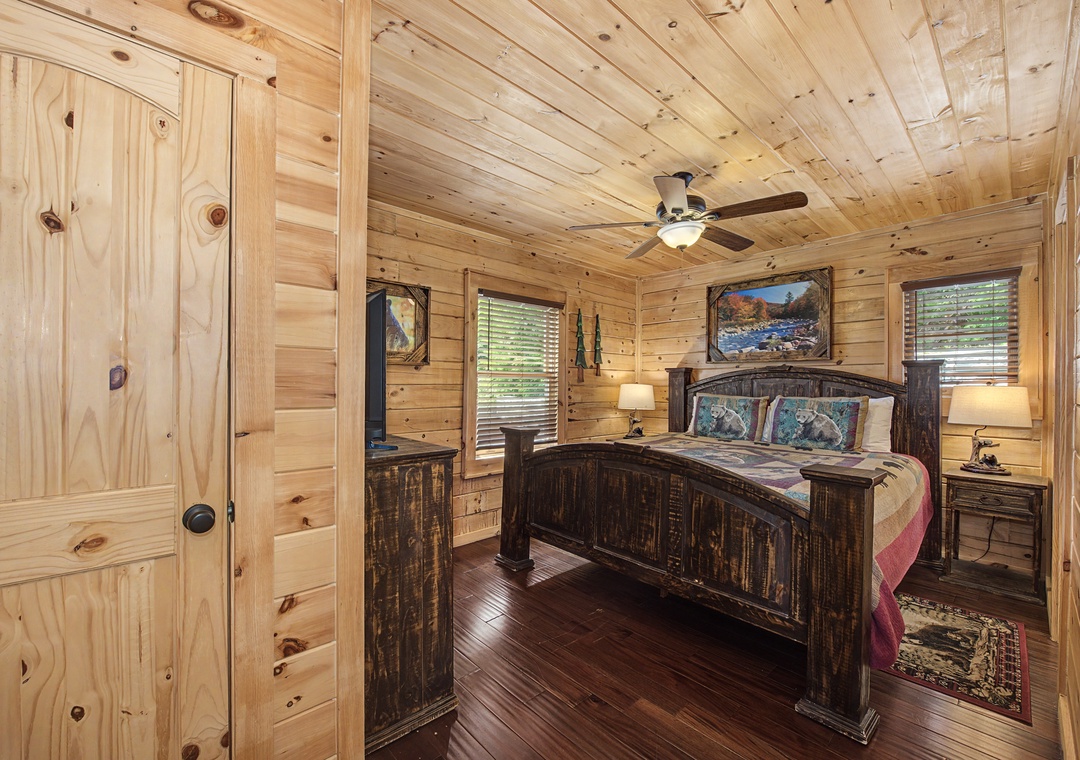 Step into your private retreat with warm wood finishes, a plush king bed, and rustic charm that invites restful nights under the gentle ceiling fan.