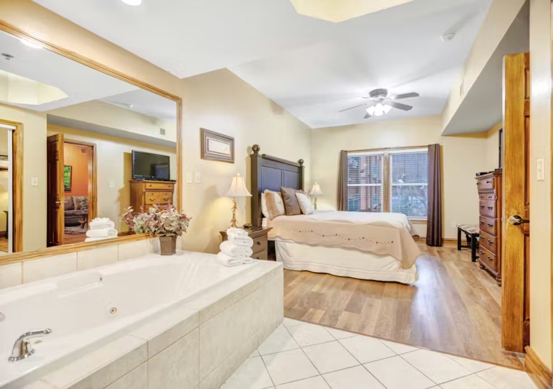 Unwind in your luxurious master suite with a romantic jetted tub, plush king bed, and city views through large windows.