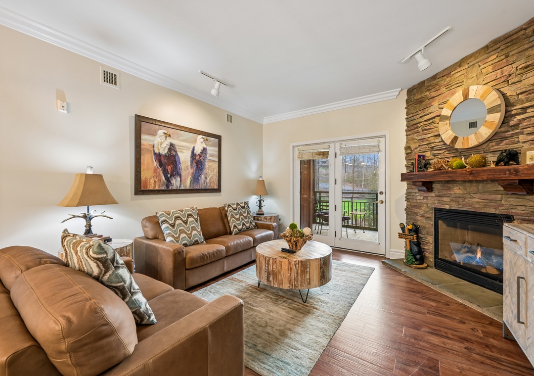 Sink into soft leather sofas by your crackling fireplace, where rustic charm meets modern comfort in this inviting living space.