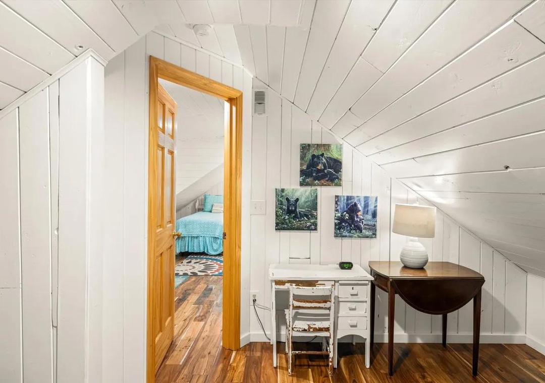This cozy upstairs nook offers you a quiet workspace or creative corner, complete with charming sloped ceilings and warm natural light. Perfect for catching up on emails or simply enjoying a peaceful moment away.