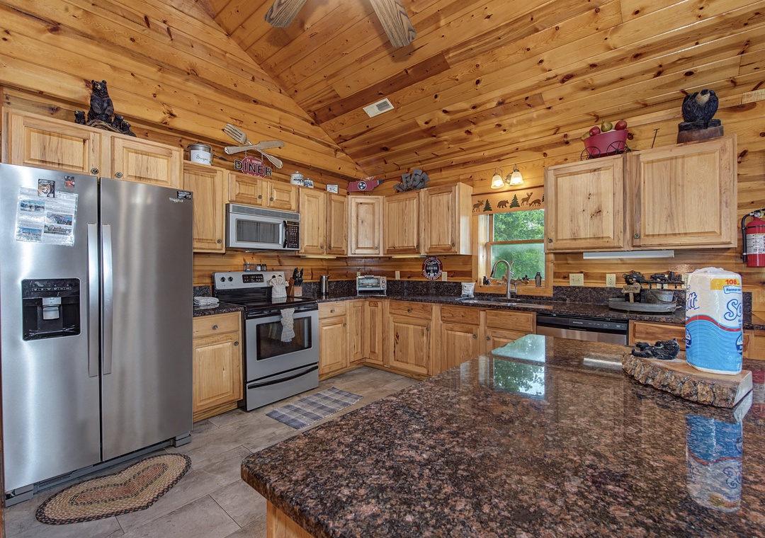 Gather around the spacious granite island in your fully equipped cabin kitchen, where rustic wood beams and modern stainless appliances blend perfectly for your mountain getaway.