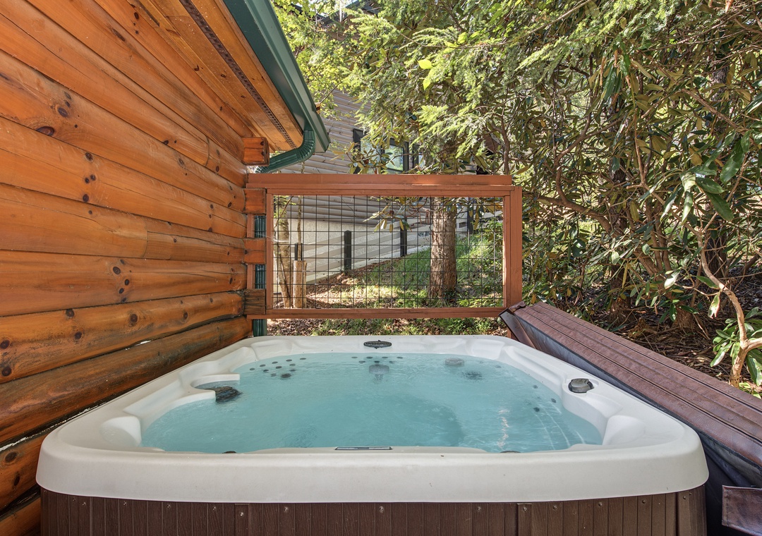 Slip into your private hot tub surrounded by towering trees and the soothing sounds of nature—your perfect woodland escape awaits.