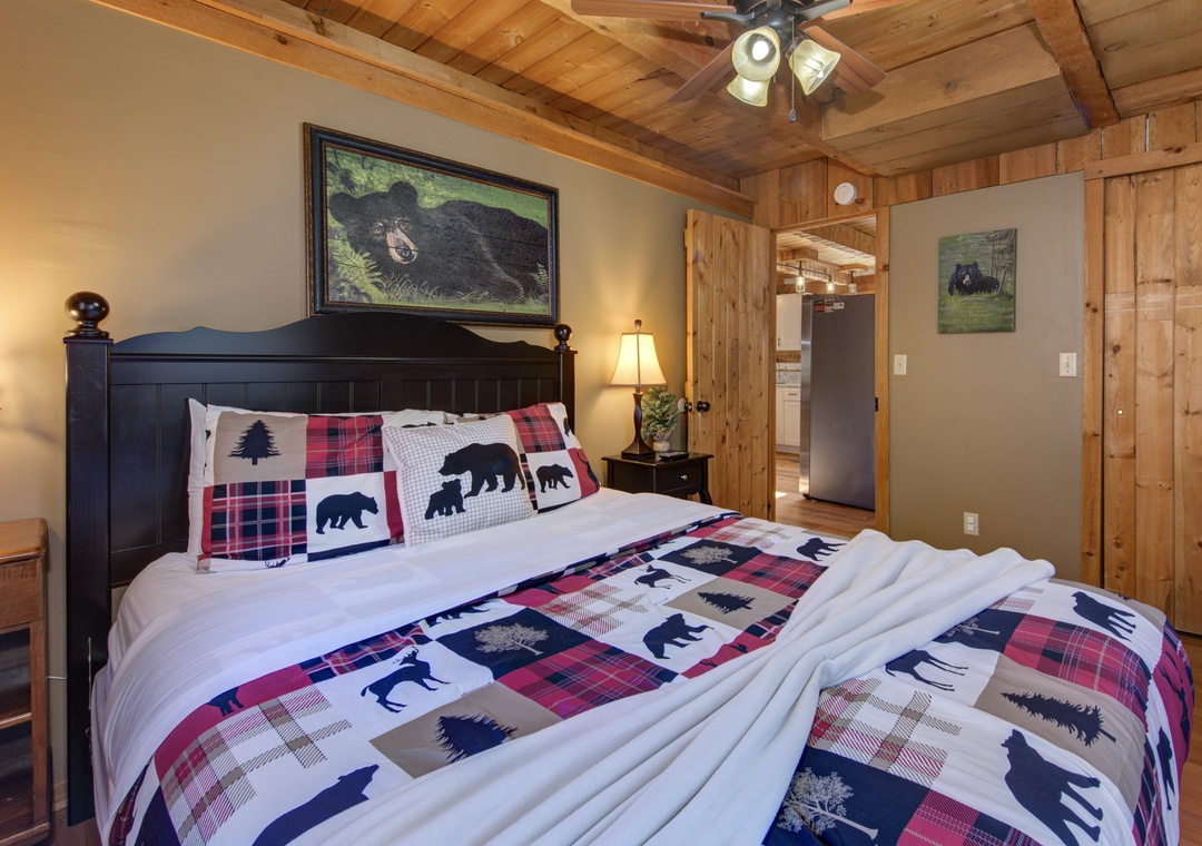 Your cozy bedroom features rustic wood beams, wildlife-themed bedding, and warm lighting for peaceful mountain retreats.