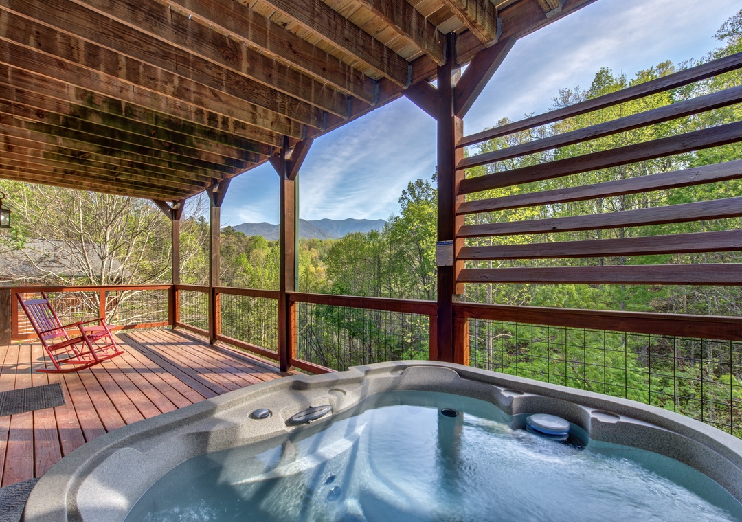 Unwind in your private hot tub while soaking in stunning mountain views from this peaceful covered deck.