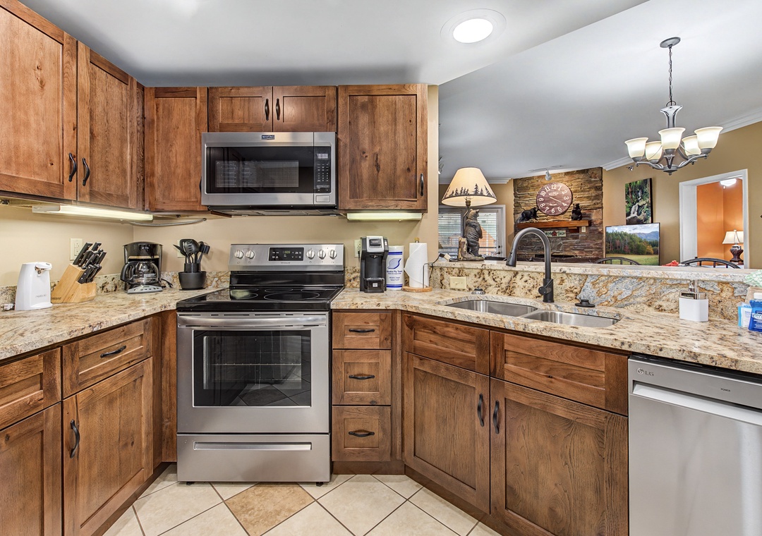 Whip up your favorite meals in this fully-equipped kitchen featuring granite counters, stainless appliances, and rustic wood cabinets.