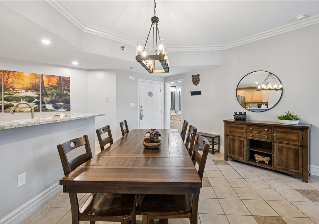 Gather around your spacious dining table for memorable meals under the warm glow of rustic chandelier lighting.