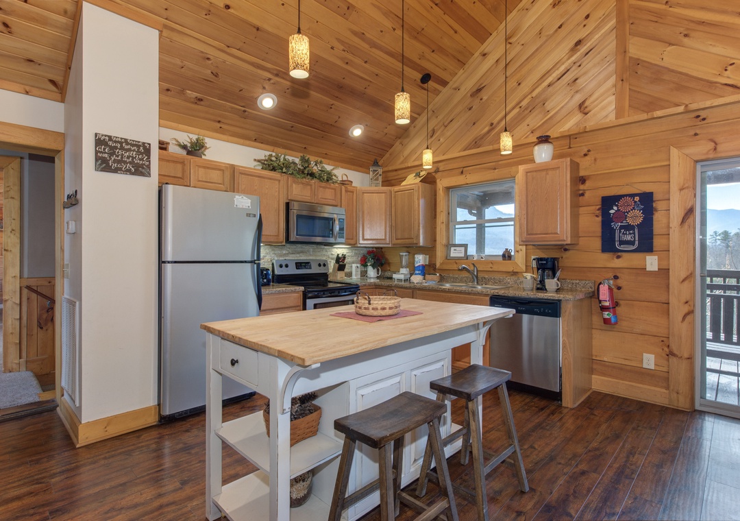 Cook your favorite meals in this fully-equipped kitchen with warm wood surroundings, granite counters, and charming pendant lighting.