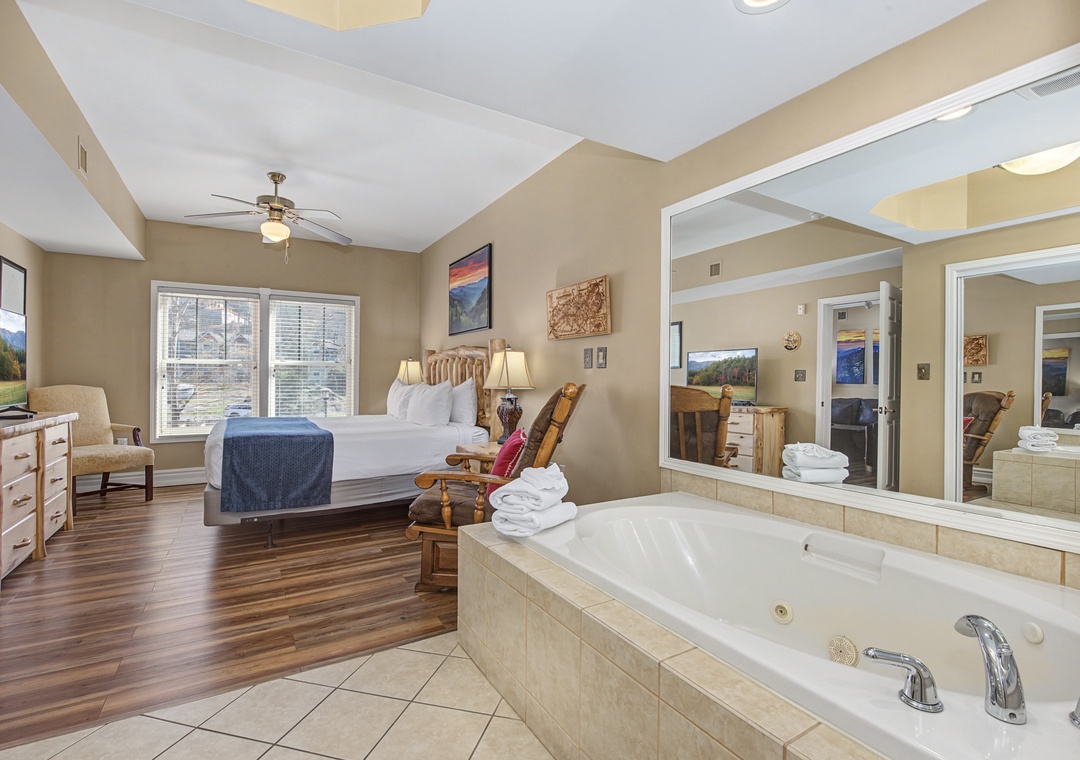 Relax in your luxurious suite featuring a king bed and private jetted tub, creating the perfect romantic retreat.
