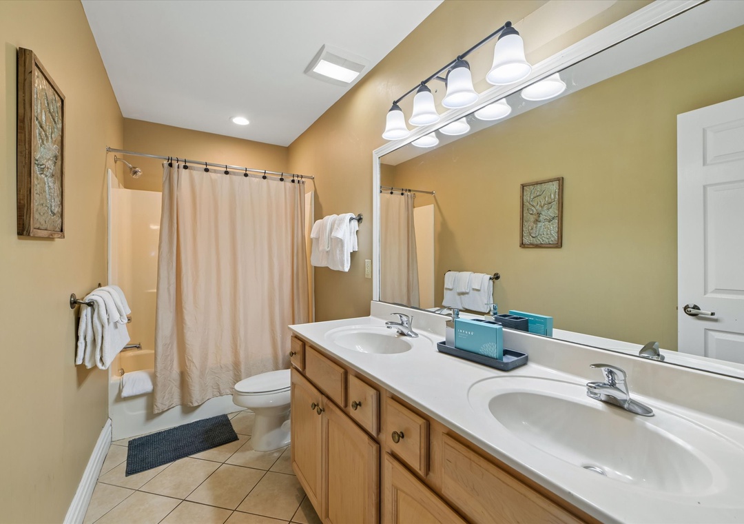 Freshen up in your spacious bathroom with dual sinks, perfect for sharing morning routines with plenty of counter space for all your essentials.