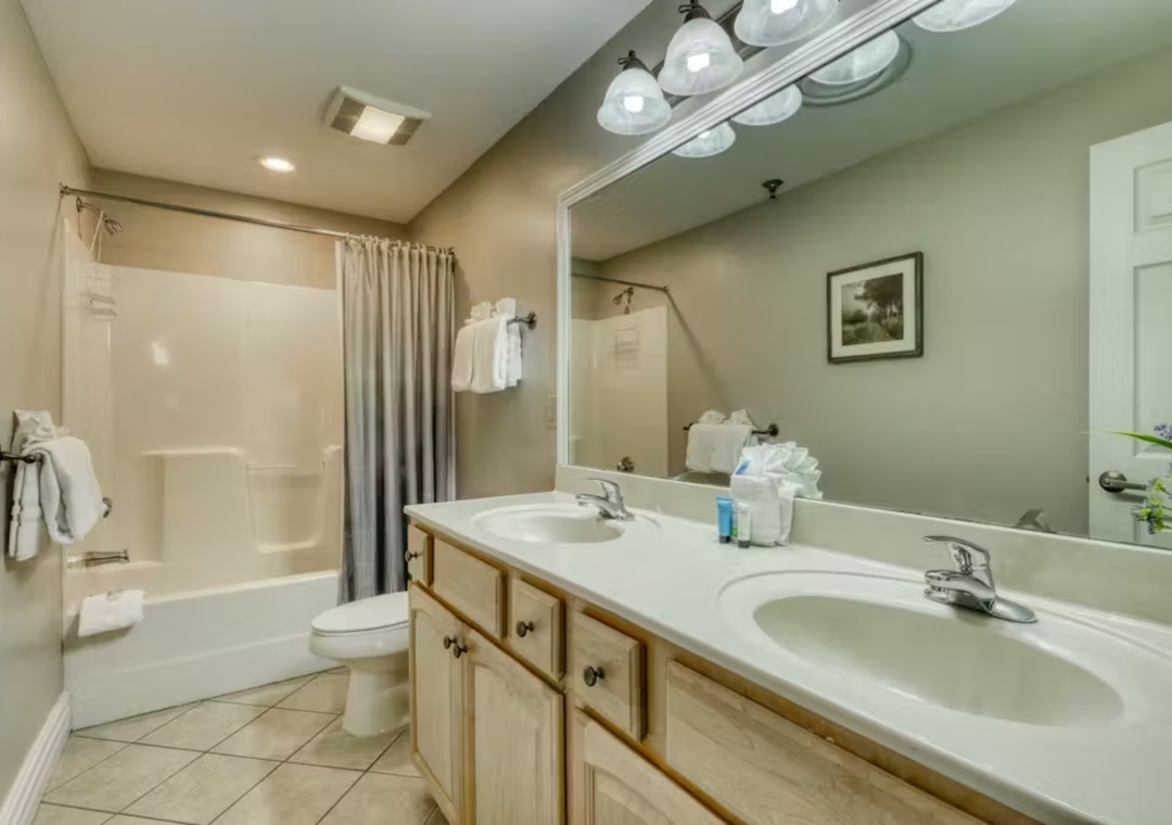 Your spacious bathroom features dual sinks, a relaxing shower-tub combo, and thoughtful touches like fresh towels and amenities.
