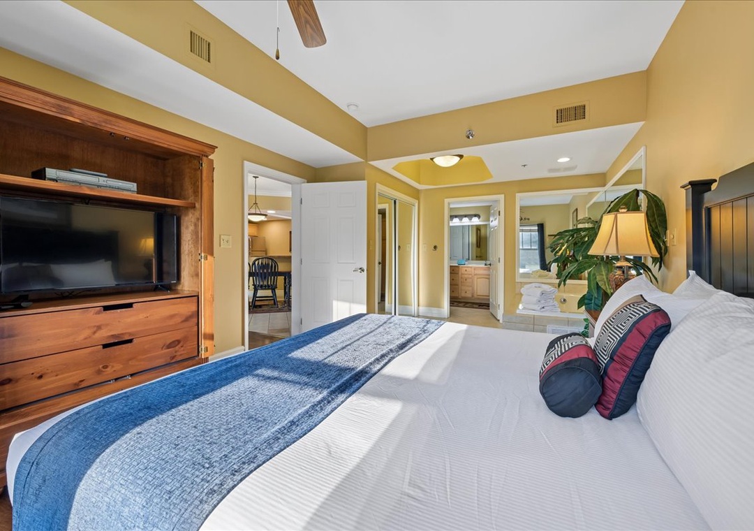 Sink into your spacious master suite with crisp linens, warm wood furnishings, and an entertainment center for peaceful evenings.