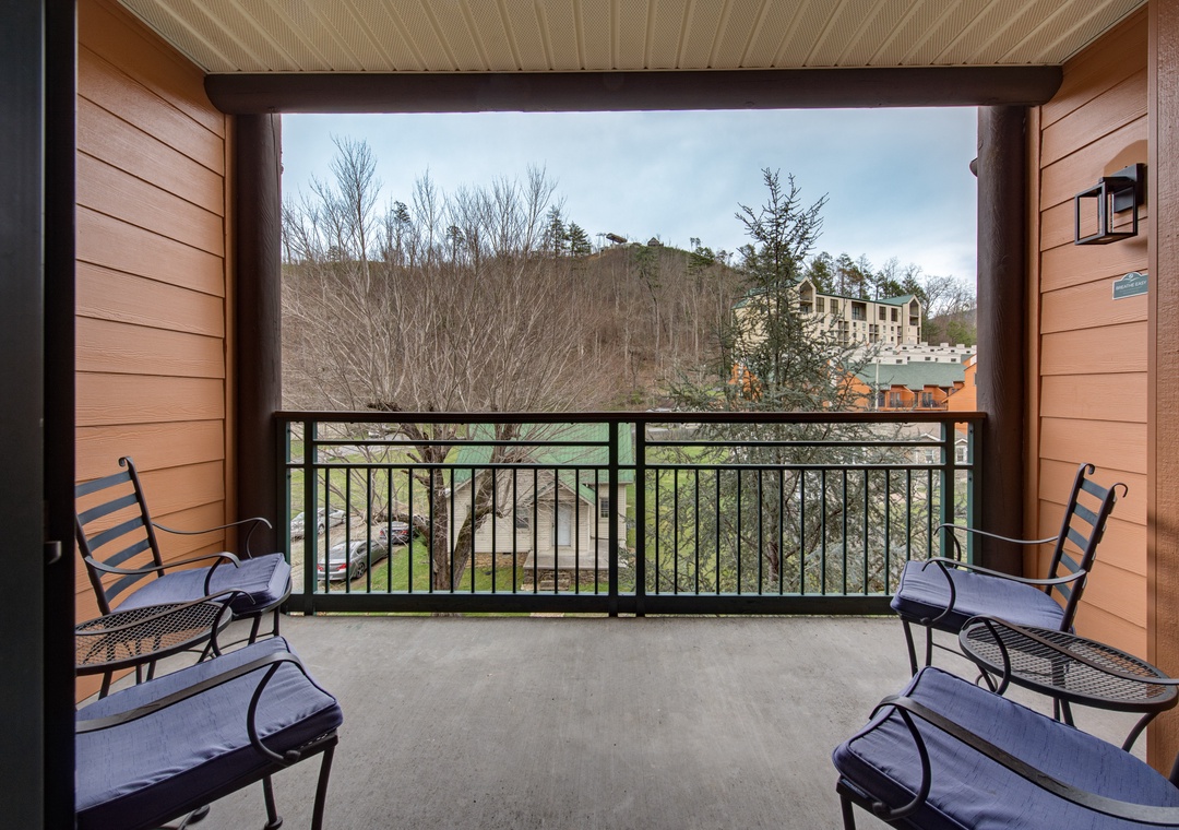 Unwind on your private covered balcony with comfortable seating as you take in the peaceful mountain views and natural landscape.