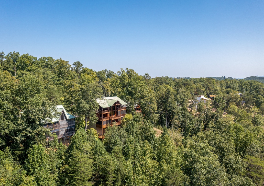 The property sits nestled in lush forested hills, offering a peaceful mountain retreat surrounded by nature.