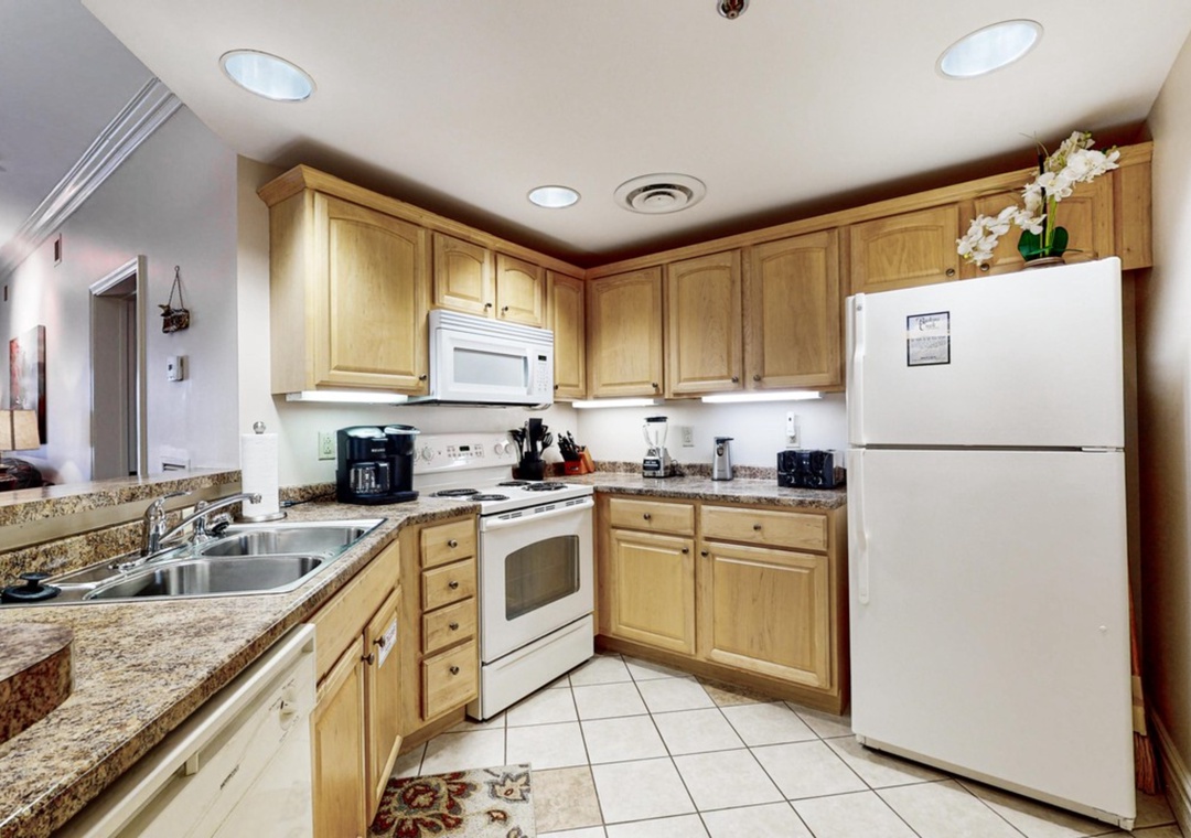 Your fully equipped kitchen features granite counters, maple cabinets, and everything needed to prepare meals during your stay.