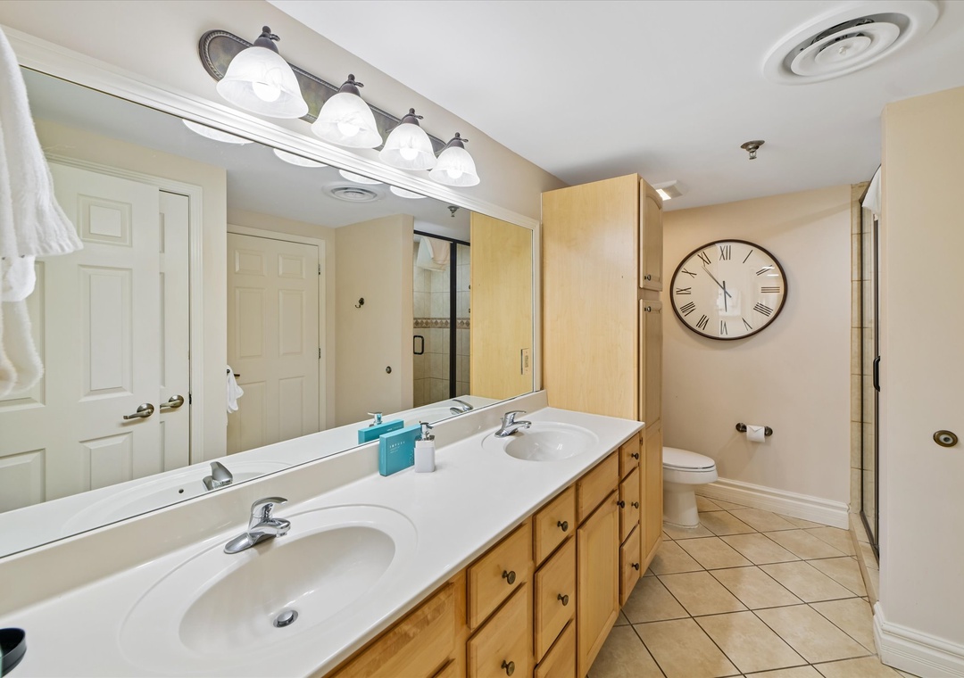Refresh in your spacious master bathroom featuring double vanities, elegant fixtures, and a relaxing tub for unwinding after your adventures.