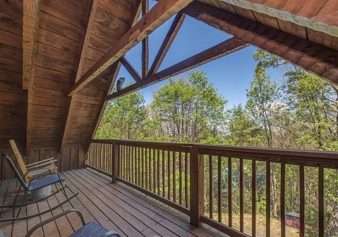 Unwind on your private covered deck with peaceful forest views and comfortable seating for morning coffee or evening relaxation.