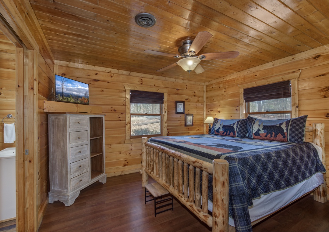 Relax in this cozy log cabin bedroom with rustic charm, soft lighting, and peaceful views through your windows.