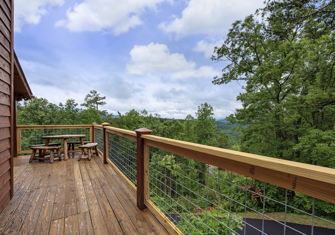 This spacious deck overlooks majestic mountain views and lush forests, perfect for morning coffee or evening relaxation. Enjoy fresh air and natural beauty from your private outdoor retreat.