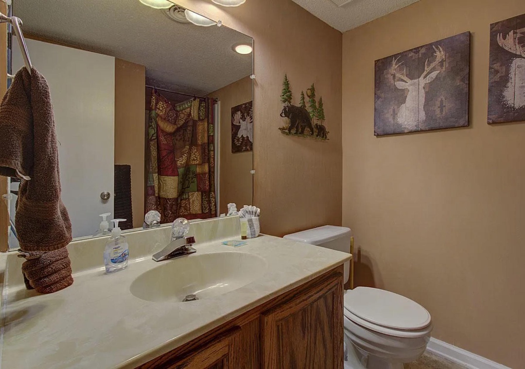 Refresh in your private bathroom with rustic cabin charm, featuring warm woodland decor and plush towels for your comfort.