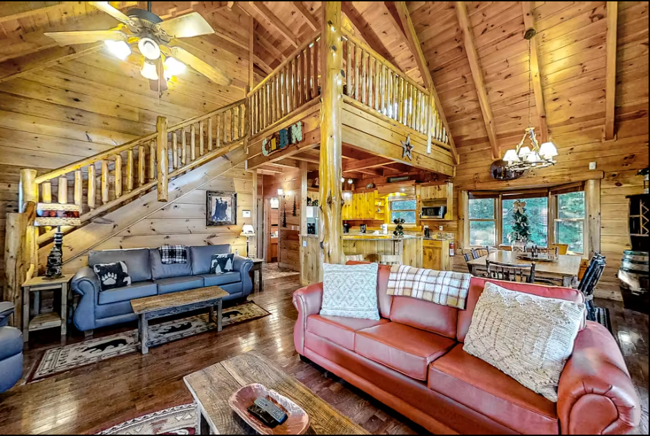 Unwind in your cozy log cabin retreat with vaulted ceilings, leather sofas, and rustic charm creating the perfect mountain getaway.