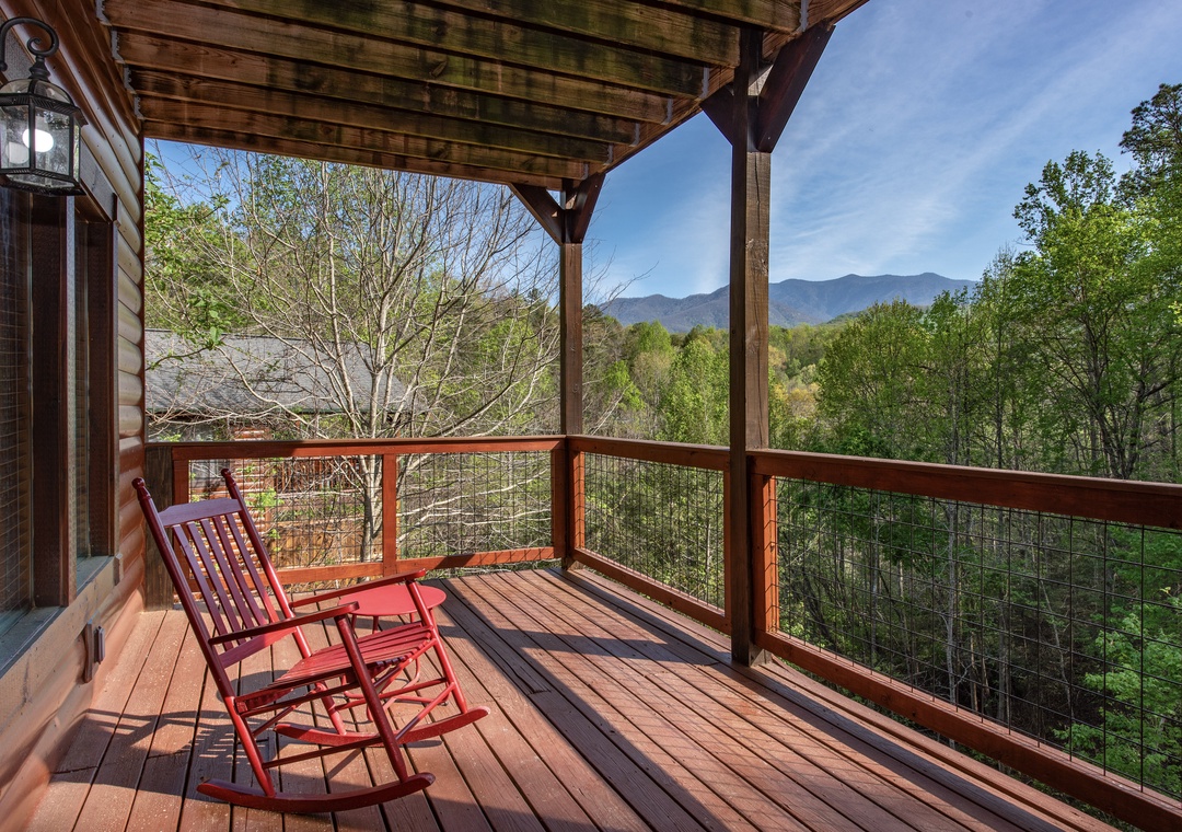 Relax in your private rocking chair while taking in breathtaking mountain views from this peaceful covered deck.