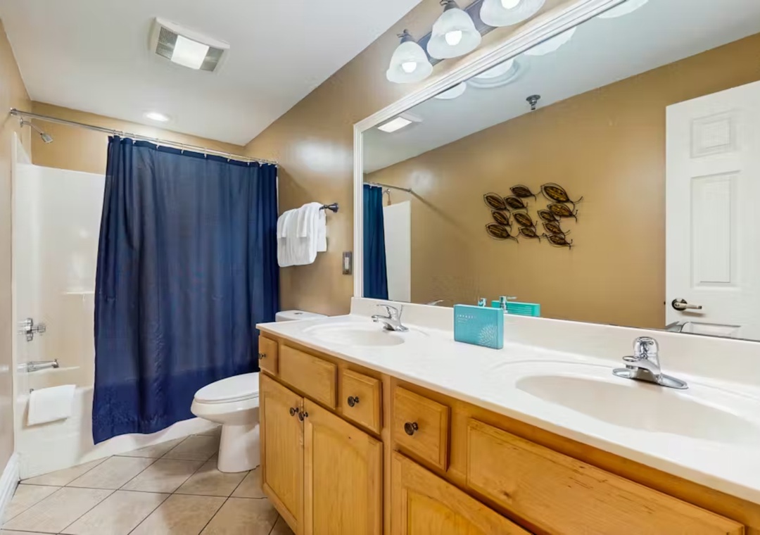 Your spacious bathroom features double sinks, ample counter space, and a relaxing tub-shower combo for unwinding after your adventures.