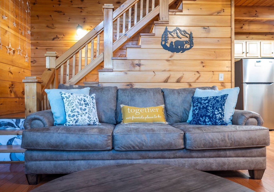 Sink into the plush sectional sofa where warm wood surroundings create your perfect mountain retreat atmosphere.