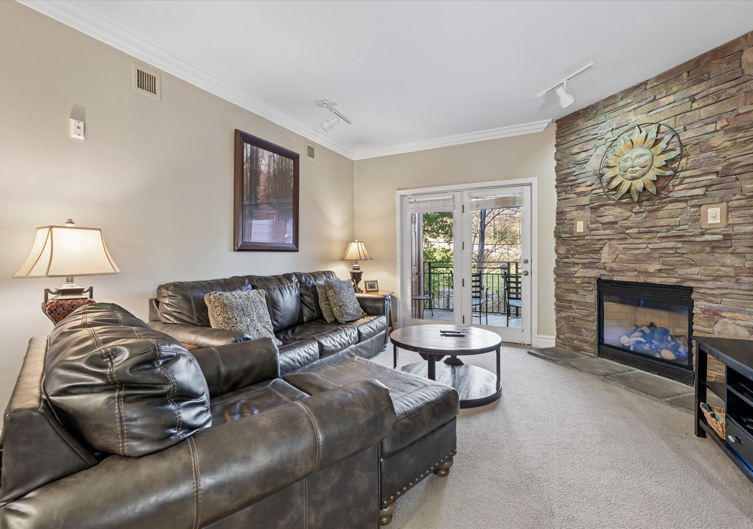 Sink into plush leather seating beside your crackling fireplace, with French doors opening to your private balcony for perfect relaxation.