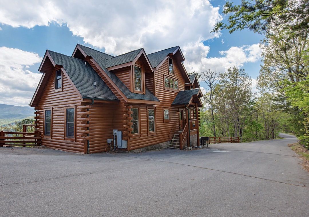 This beautiful log cabin features rustic charm with modern amenities, surrounded by lush mountain forests and convenient paved parking.