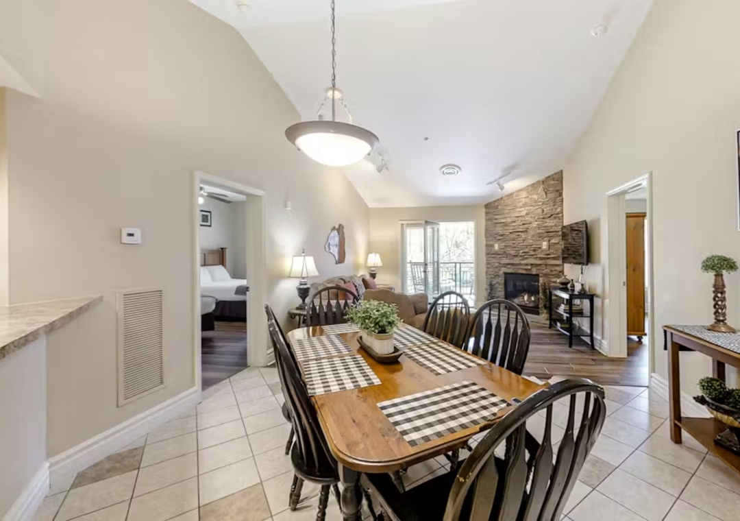 Gather around your spacious dining table for meals while enjoying the cozy fireplace and open layout connecting to the living area.