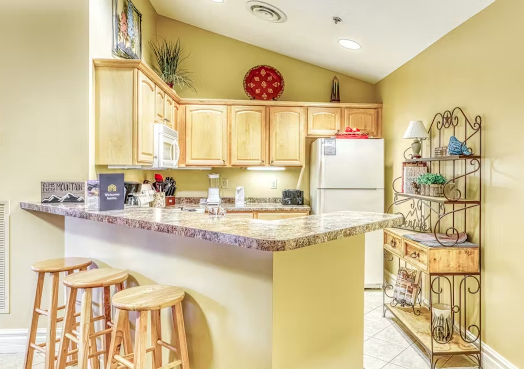 Your fully equipped kitchen features granite counters, bar seating, and everything needed to prepare memorable meals during your stay.