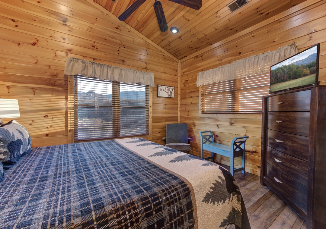 Drift off surrounded by warm knotty pine walls and mountain views through your windows. The plaid bedding and cozy wood tones invite you to unwind after a day of adventure.
