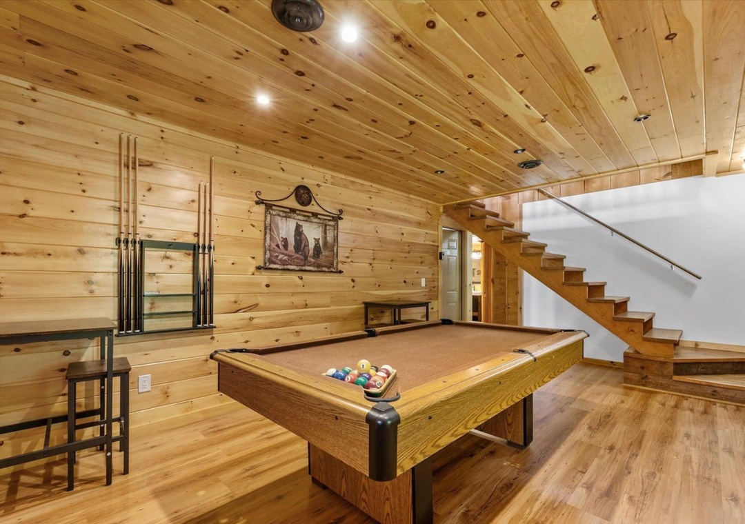 Challenge friends to a game in your private billiards room, complete with rustic wood beams and cozy cabin atmosphere.