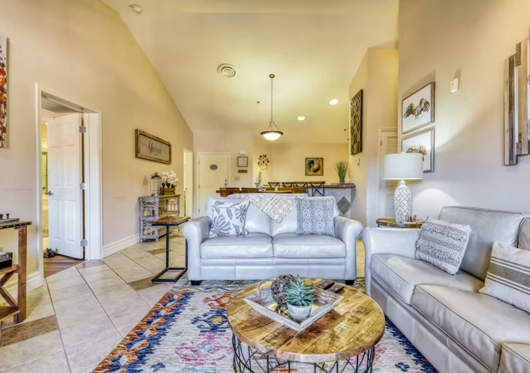 Settle into your spacious living room with plush gray sofas and warm southwestern touches that create the perfect gathering space.