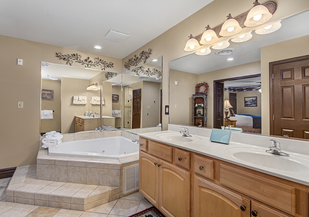 Unwind in your luxurious master bathroom with a jetted tub, dual vanities, and elegant lighting that creates the perfect spa-like retreat.