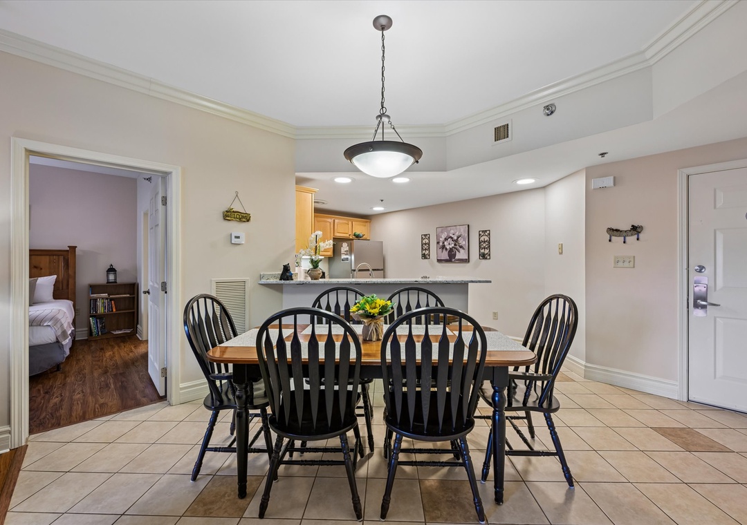 Gather around this inviting dining table for six, where your mornings begin with coffee and conversation, and evenings wind down with shared meals beneath warm pendant lighting.
