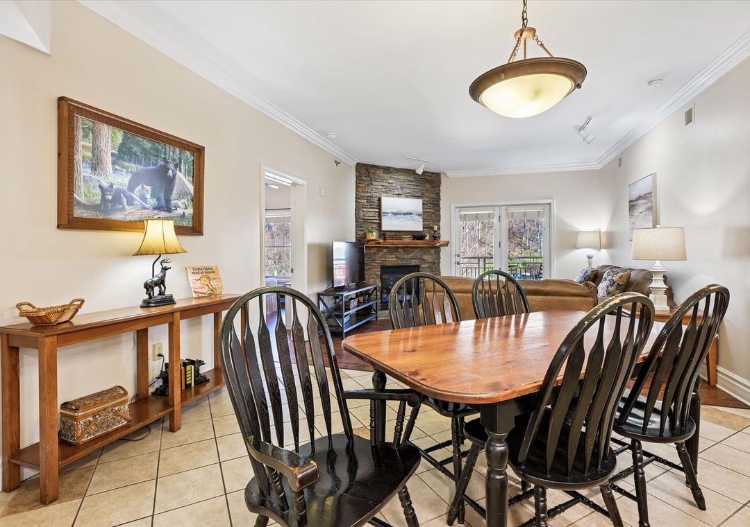 Gather around this welcoming dining table where your family meals become cherished memories, warmed by the cozy fireplace.