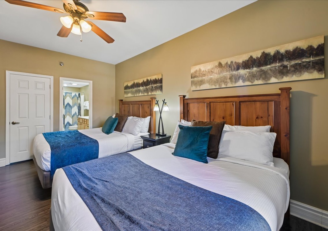 Drift off to sleep in your comfortable twin beds with crisp linens and mountain artwork creating a peaceful retreat.