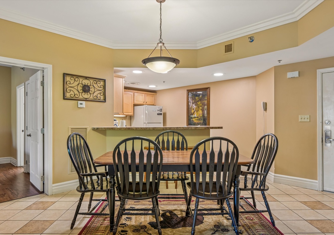 Gather around your spacious dining table for memorable meals together, with warm lighting and an open kitchen perfect for entertaining.