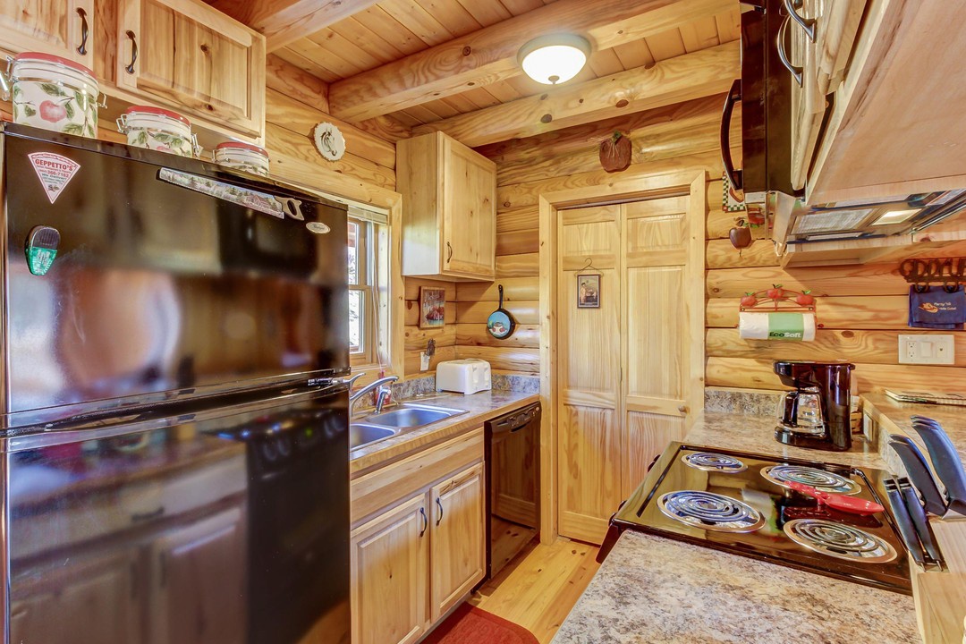 Your fully-equipped kitchen features warm wood cabinetry, granite countertops, and everything you need to cook up comfort during your mountain getaway.