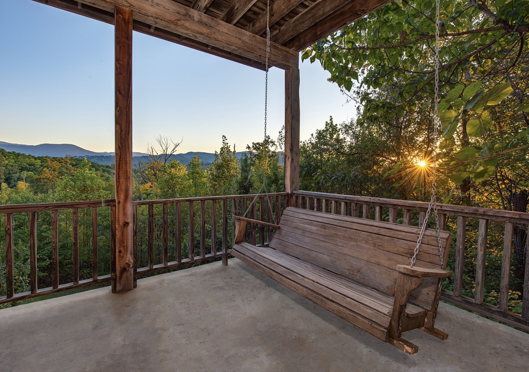 Swing gently on your private porch as the sun sets behind the mountains, painting the sky in warm hues. Surrounded by rustling trees and peaceful views, this is your perfect spot to unwind after a day of adventure.