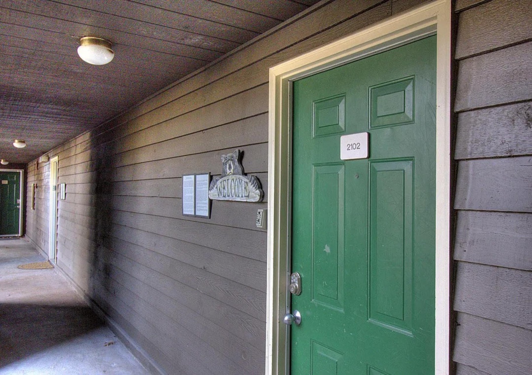 Your charming green door welcomes you to room 202, where comfort awaits in this cozy lakeside retreat.