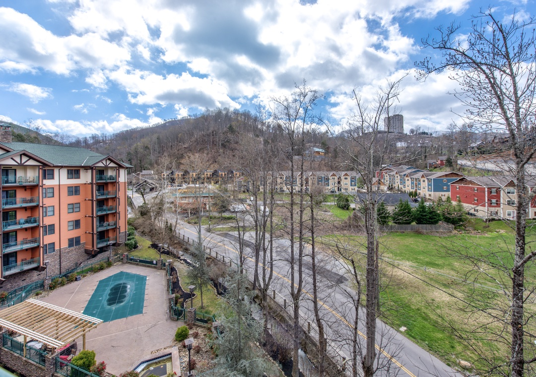 Mountain resort views showcase forested hillsides, colorful buildings, and recreational amenities in a scenic valley setting.