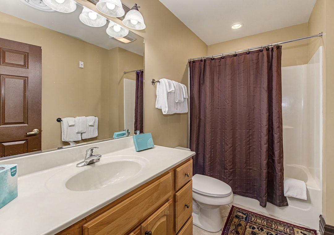 Step into your private bathroom with warm lighting, fresh towels, and everything you need for a comfortable stay.