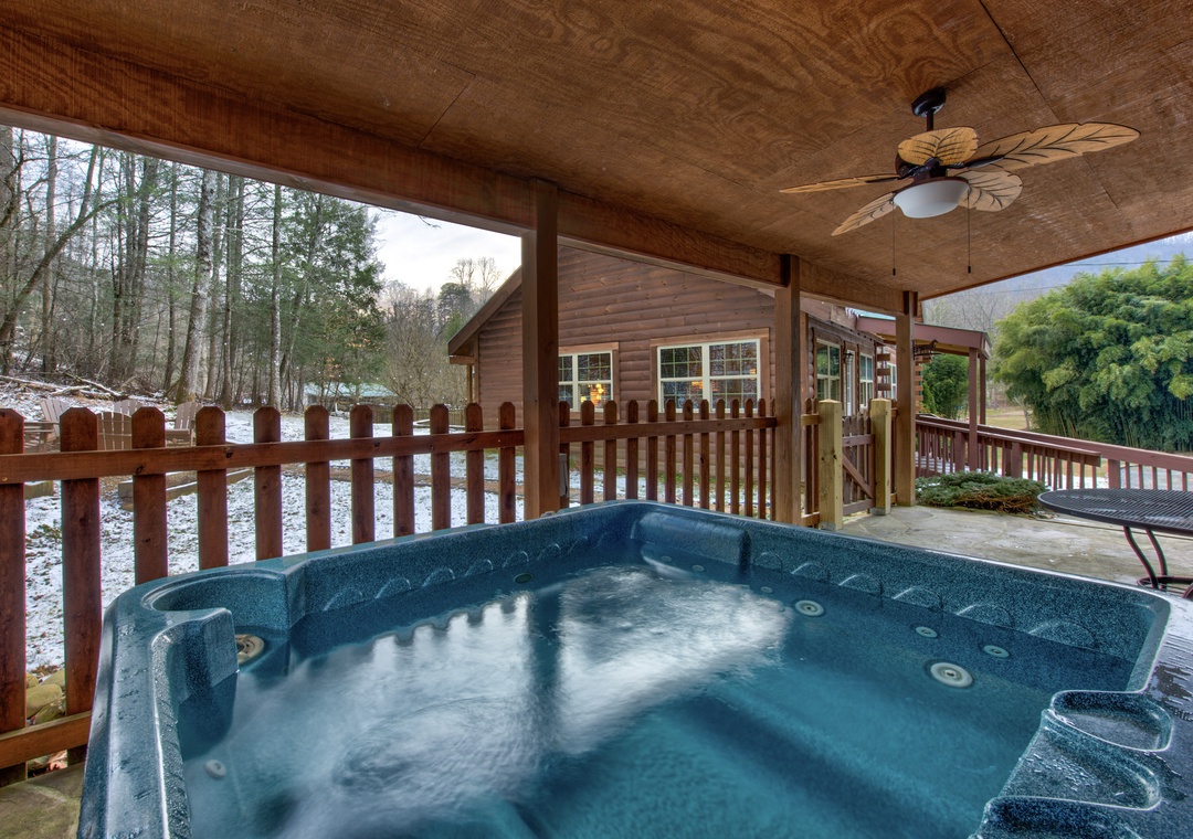 Soak in your private hot tub on the covered deck, surrounded by peaceful winter woods and mountain views.